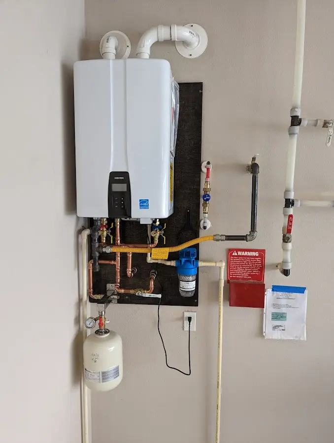 Professional plumber installing copper piping in a Timonium home